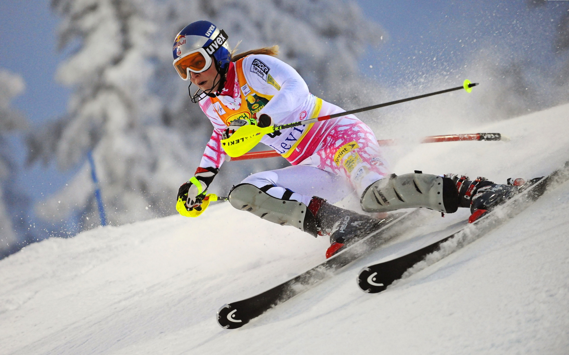 woman ski athlet racing with yellow gloves