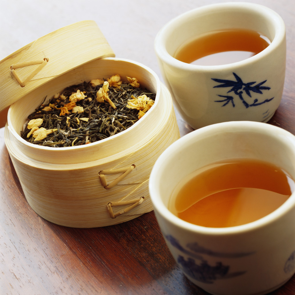 Teacups and Dried Tea Leaves in Bamboo Container