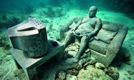 Underwater Museum in Cancun man watching tv sclupture