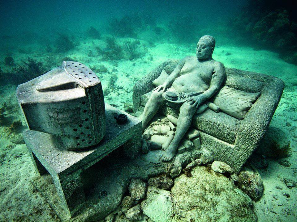 Underwater Museum in Cancun man watching tv sclupture