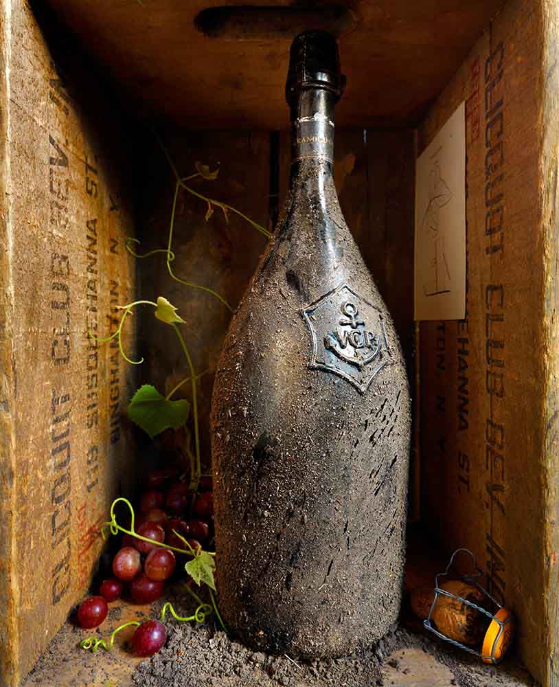 Old wine bottle with grapes and corc