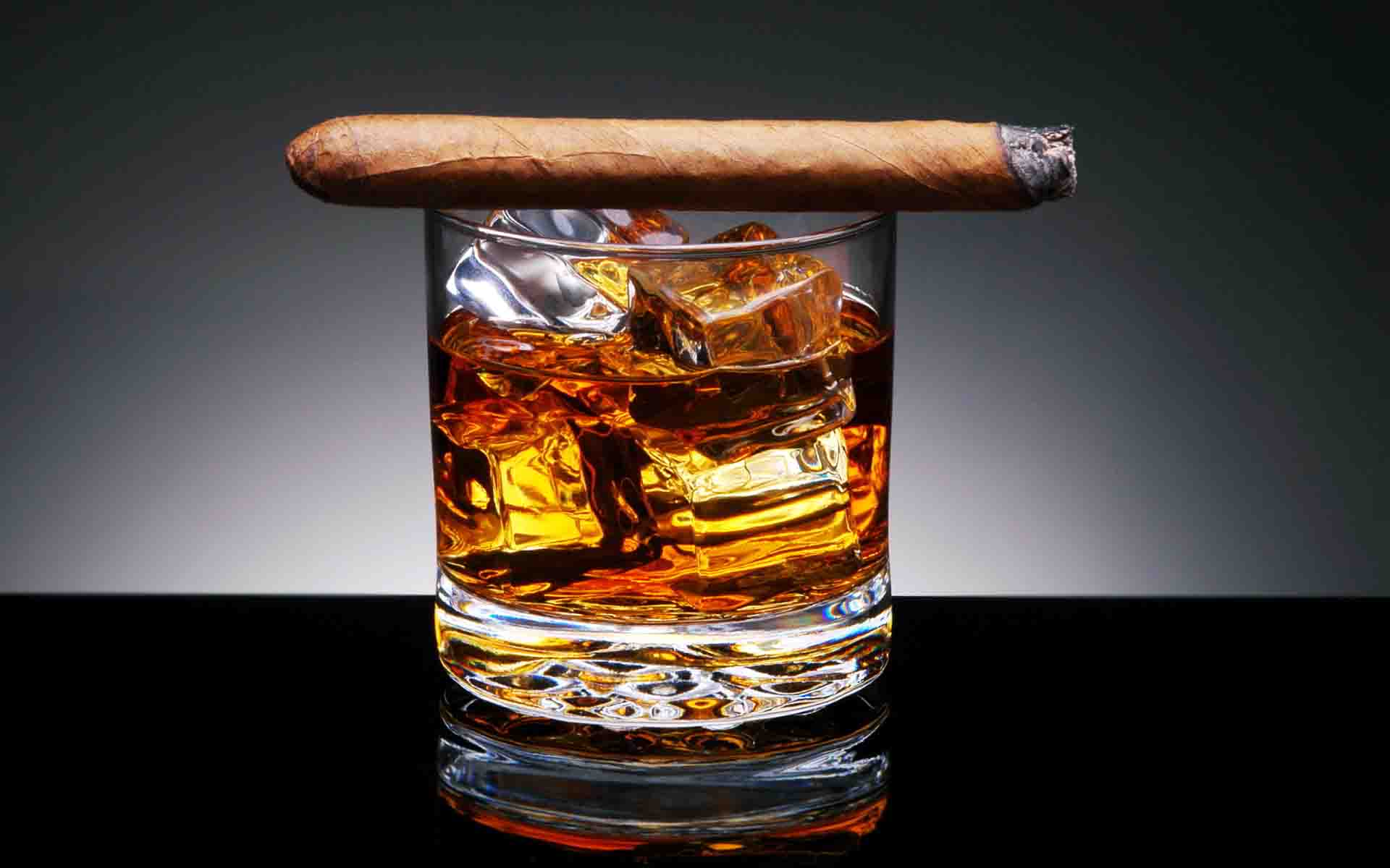 Whiskey in glass with cigar The whiskey was initially colorless