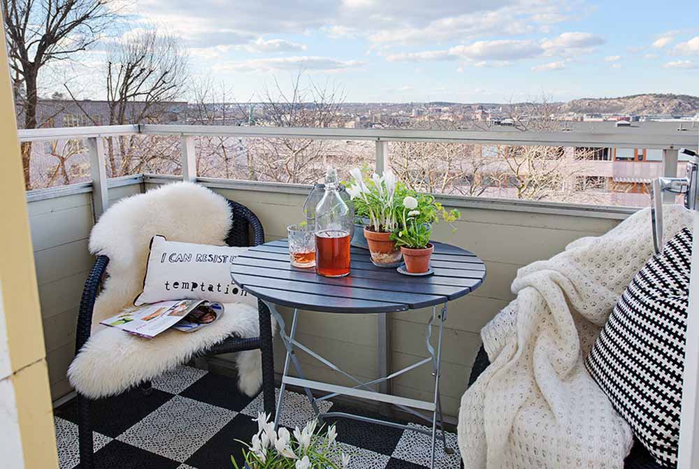 small balcony apartment with white blankets