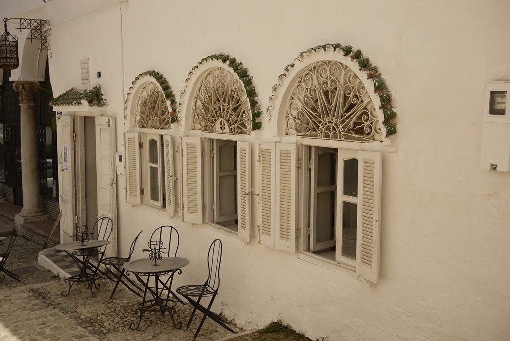 Tangier morocco street view with chairs in front of white facades