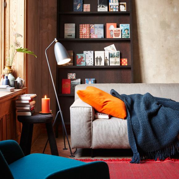 living-room-decoration-floor-lamp-modern-open-bookcase-sofa-gray-pillow-cuddly-blanket-work-table-books-orange-red-blue-living-ideas