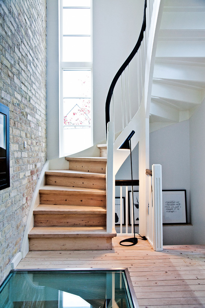 brick-wall-curved-staircase-glass-floor-scandinavian-design