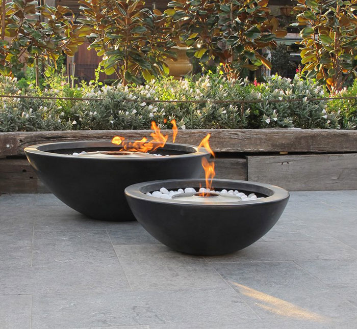 garden-outdoor-fireplace-stones-hozl-plants-shrubs-around-decoration-from-concrete