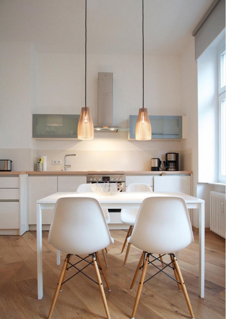 Simple white dining table and Eames chairs in modern kitchen-dining tables