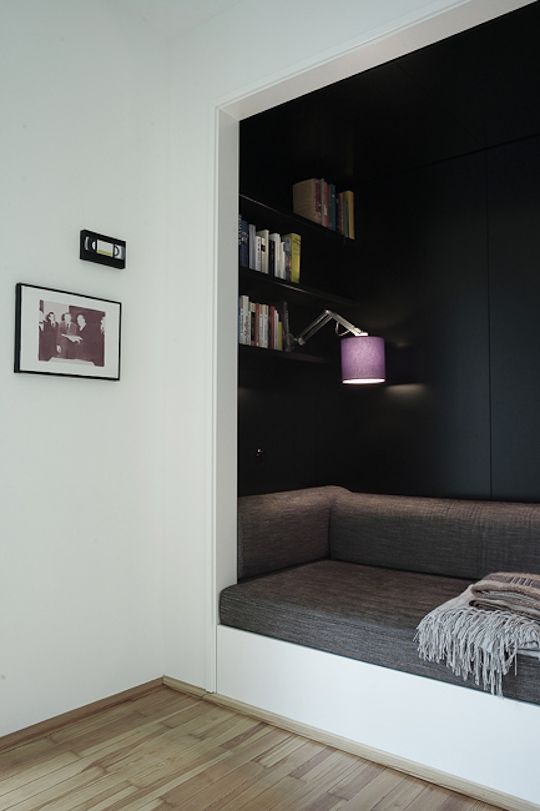 minimalistic reading nook in grey colors purple lamp