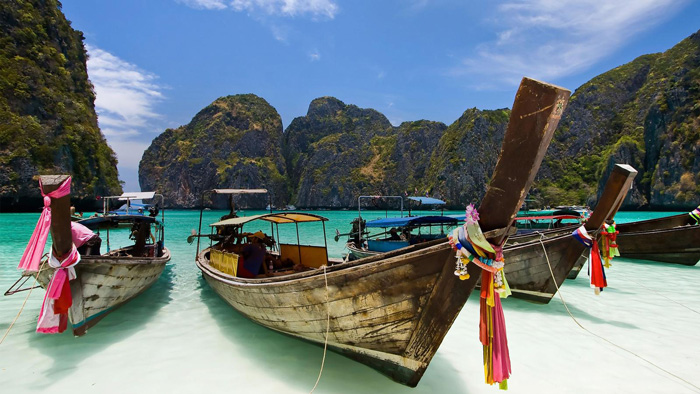 Boats-Parked-on-a-Sandy-Beach-Thailand-Top-5-Tropical-Destinations-That-Will-Make-You-Forget-About-the-Winter