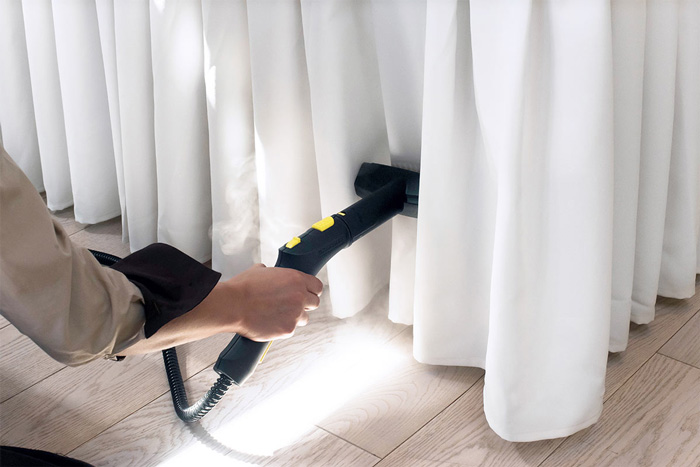Cleaning-Home-Curtains-from-Dust-with-Vacuum-Cleaner
