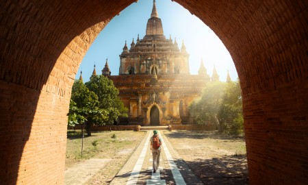 Traveler walking along road to Htilominlo temple in Bagan. Burma