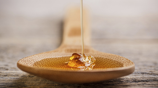 Natural honey in wooden spoon