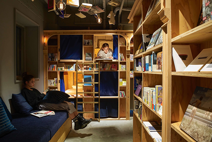 Women reading and resting in book and bed bookstore Tokyo 