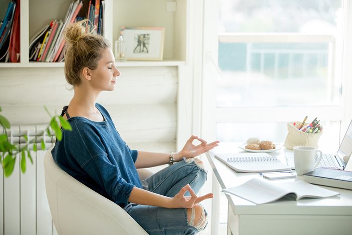 Woman doing desk yoga 