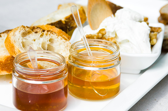 Small jars full of honey for breakfast