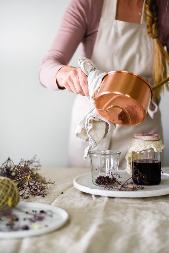 Woman making Homemade Elderberry Syrup and Jam