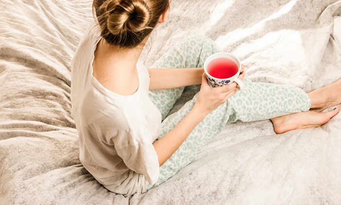 Woman drinking tea before sleep ritual