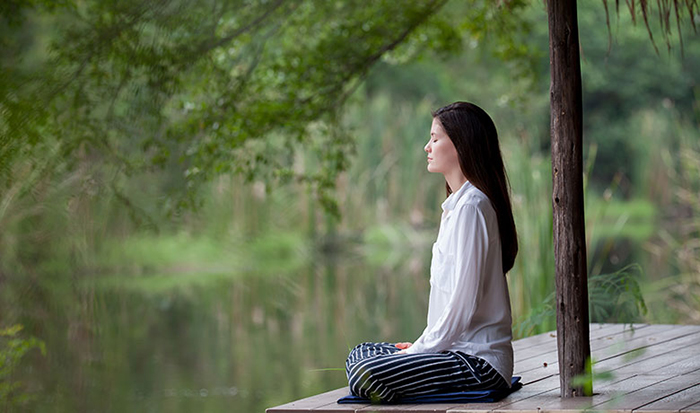 Woman having Silent Meditation near river