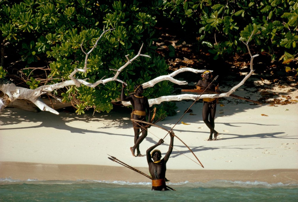 Sentinelese warriors standing at the beach holding arrows