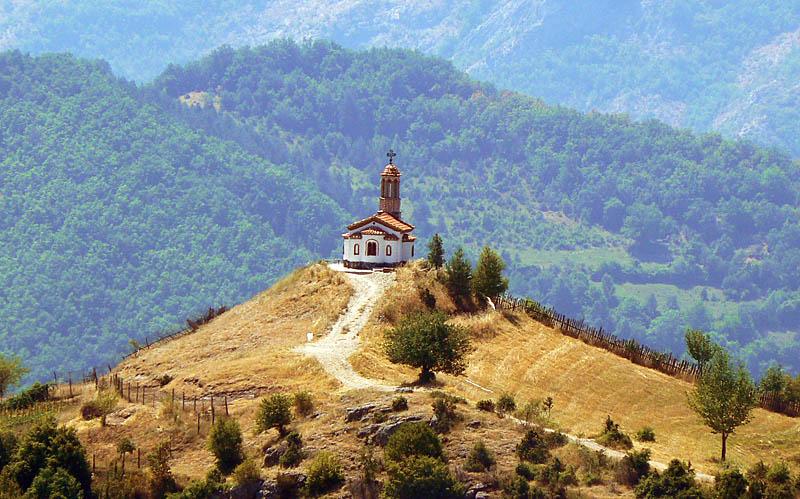 Distant photo of the church taken during autumn