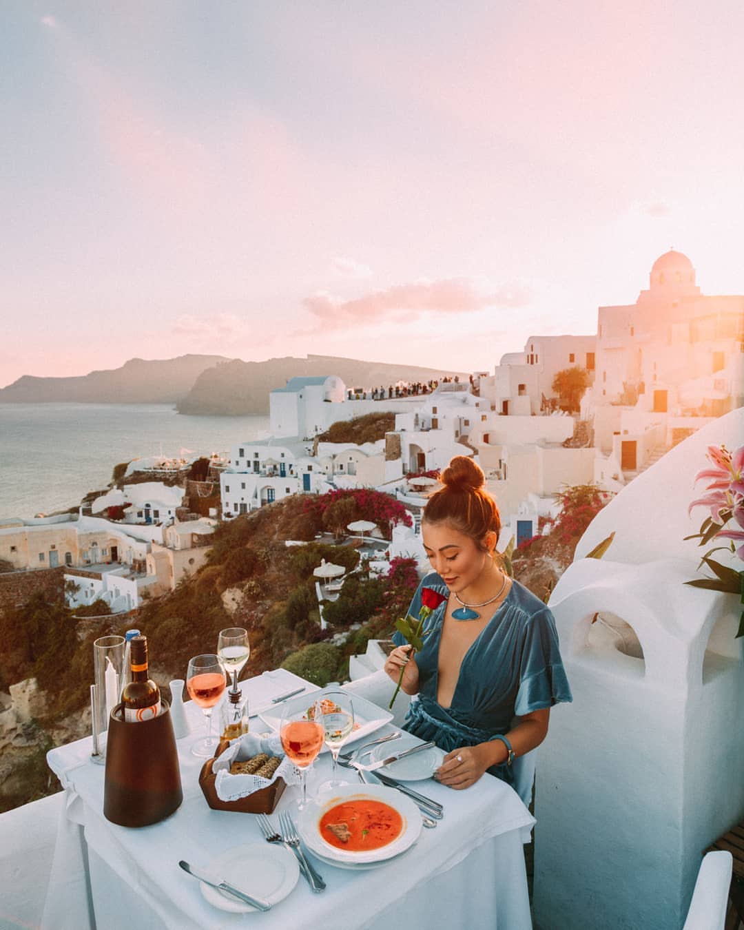 Woman having lunch at Ambrosia restaurant Santorini