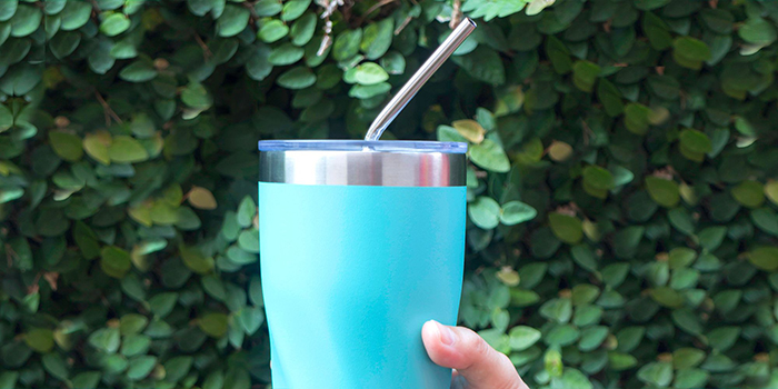 Stainless steel reusable straw in a glass