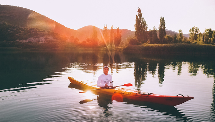 Man kayaking at sunshine in Dalmatia, Croatia