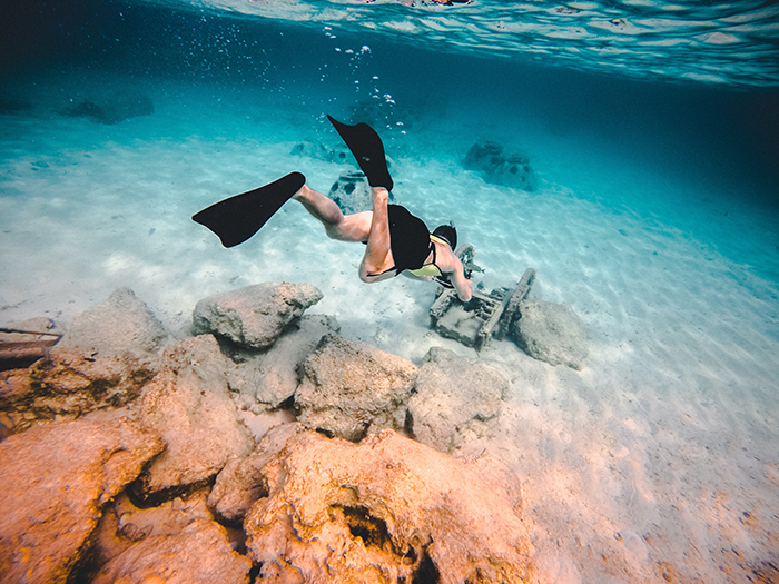 Woman diving deep into the lake