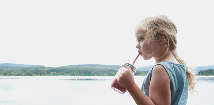 Girl drinking from reusable silicone straw