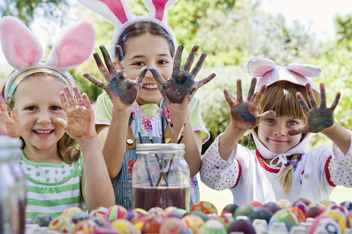 Kids coloring eggs outdoors