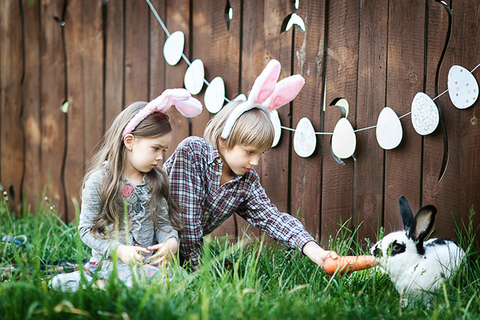 Two kids and a bunny outdoors