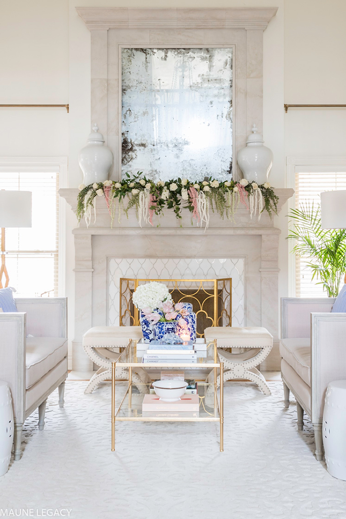 White living room with flower decor on fireplace