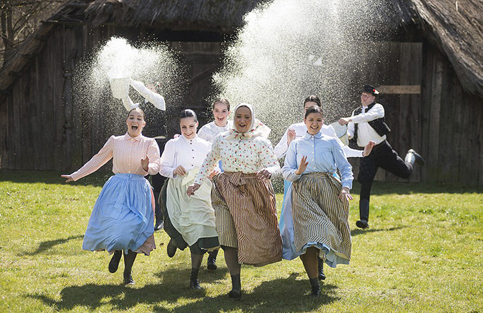 Girls running away from boys that wants to shower them with water Hungary Easter tradition