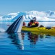 Man kayaker picturing a whale from water