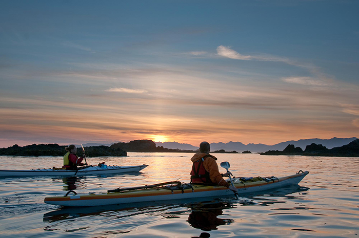 Man and woman kayaking in Vancouver Island at sunshine