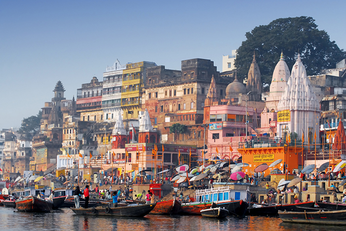 The colorful port of Mumbai full of people and boats