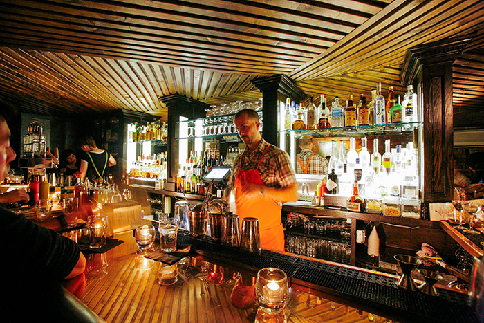 Bartender making cocktails in PDT in New York