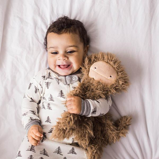 Baby boy hugging his plush toy