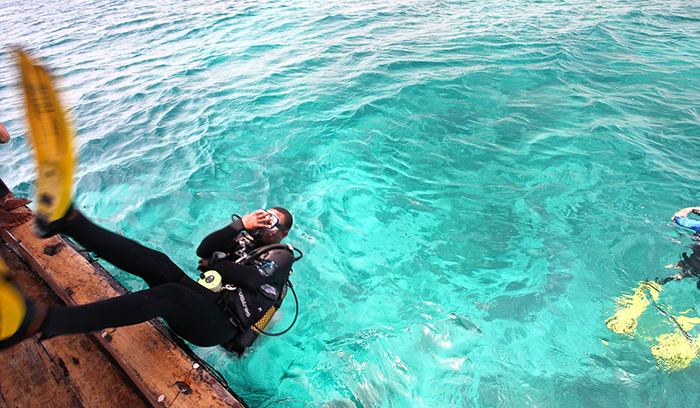 Diver going underwater in Lake Malawi, East Africa