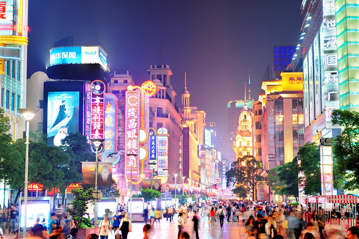 Streets of Shanghai full of people by night