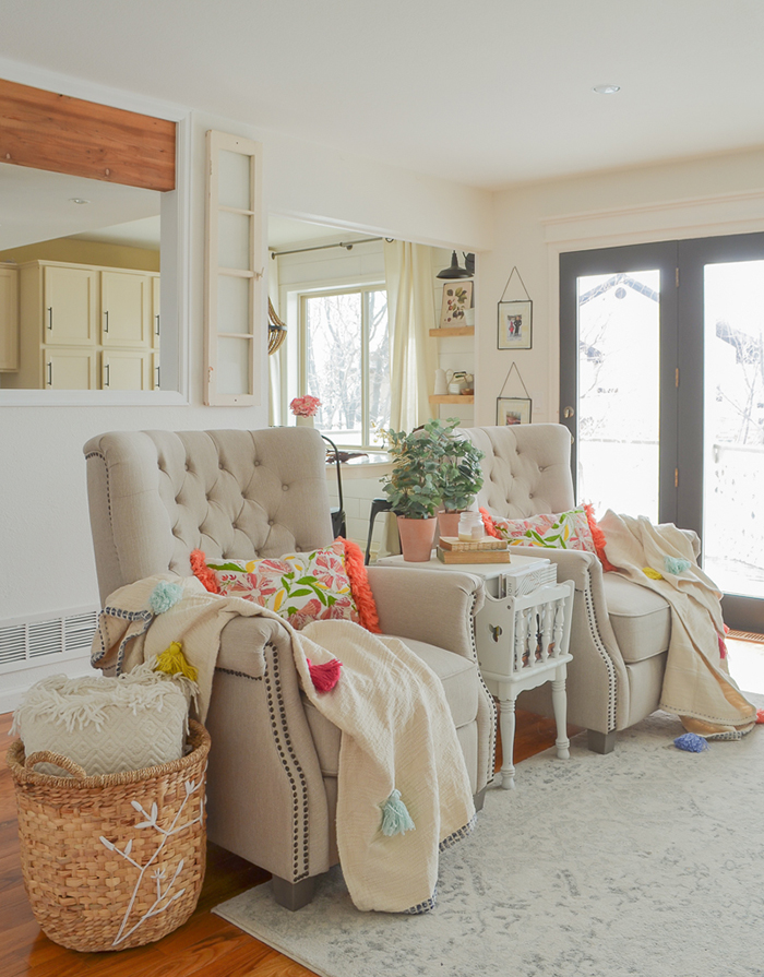 Armchairs with colorful pillows and spring decor