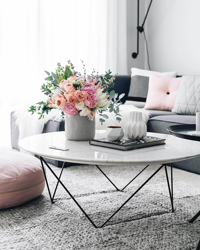 Grey table vase with fresh flowers for spring decoration