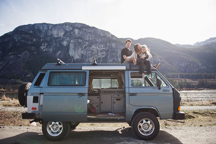 Family sitting on their house on wheels van