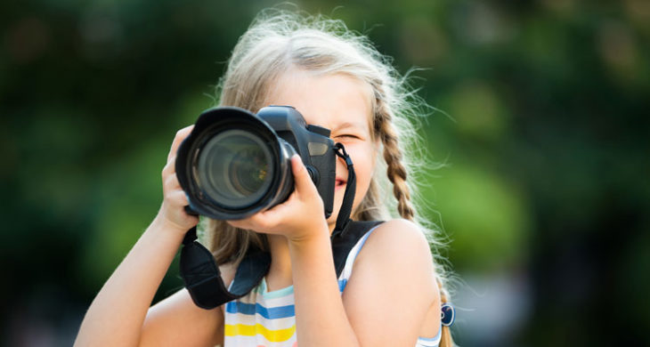 Sweet girl taking photos outside