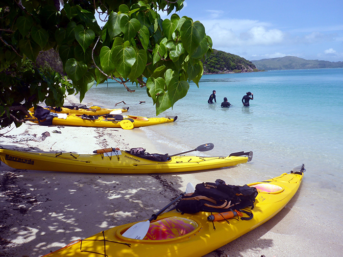 Yellow kayaks on the beach ready to go in Whitsunday Islands, Australia