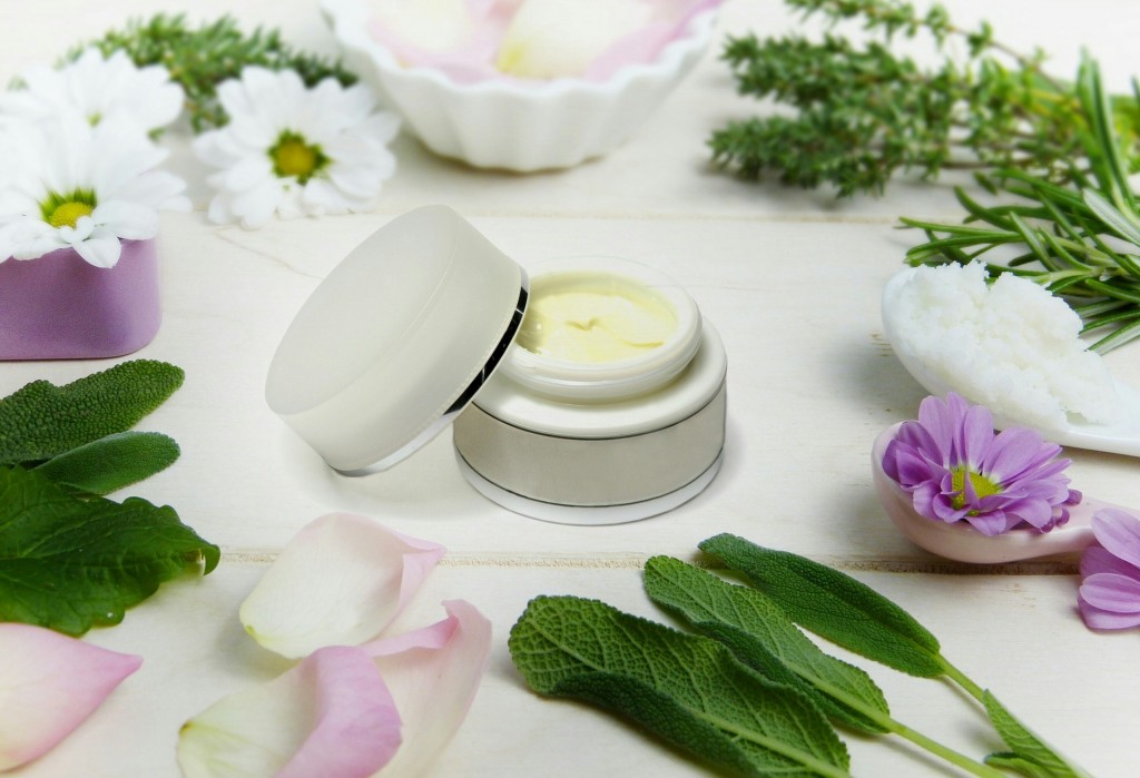 Handmade face cream and herbs around it