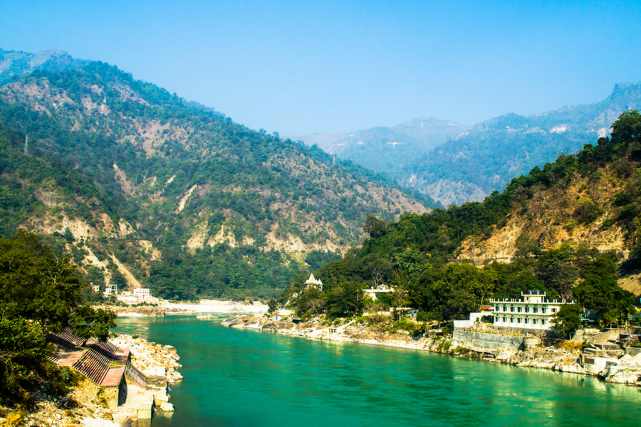 Mountains clear river surrounded with few small houses