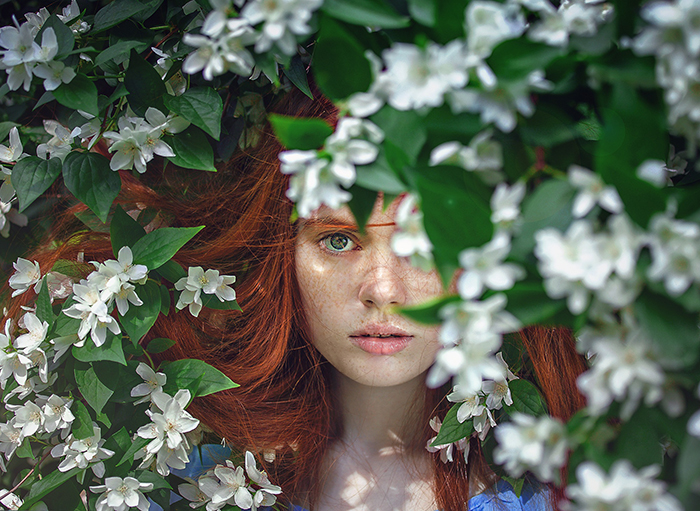 Girl behind a floral tree