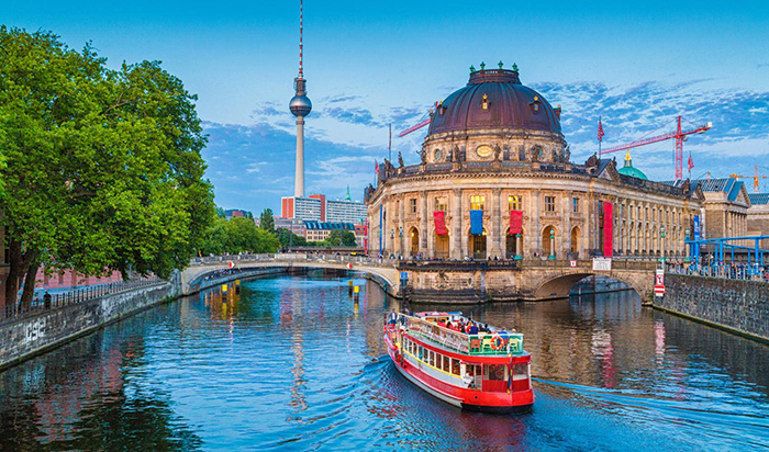 Tourists exploring Berlin on a boat with view on historical buildings